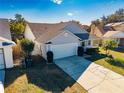 Single-story house with a two-car garage and a well-maintained yard at 5556 Elizabeth Rose Sq, Orlando, FL 32810