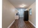 Newly renovated kitchen with white cabinets, granite countertops, and dark wood floors at 5711 Bolling Dr, Orlando, FL 32808