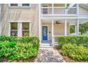 Front entrance with blue door, walkway, and landscaping at 7544 Gathering Dr, Reunion, FL 34747