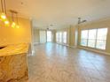 Spacious living room with tile floors and access to a balcony at 7580 Toscana Blvd # 834, Orlando, FL 32819