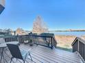 Wooden deck overlooking lake with seating for relaxing and enjoying the view at 8737 The Esplanade # 65, Orlando, FL 32836
