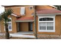 Front view of two-story house with orange exterior and tile roof at 1001 Park Ridge Cir, Kissimmee, FL 34746