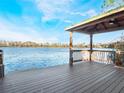 Relaxing lakeside gazebo with wooden deck overlooking the water at 10125 Canopy Tree Ct, Orlando, FL 32836