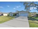 Front view of a house with a driveway and grassy yard at 1101 Swanson Dr, Deltona, FL 32738