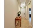 Bright and airy entryway with tile flooring and console table at 1506 Bunker Dr, Davenport, FL 33896