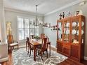 Elegant dining room featuring a wood table, hutch, and hardwood floors at 1701 Sparkling Water Cir, Ocoee, FL 34761