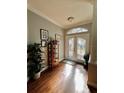 Bright entryway with hardwood floors, double doors, and decorative elements at 1701 Sparkling Water Cir, Ocoee, FL 34761