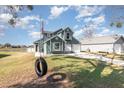 Two-story house with a green exterior, tire swing, and a spacious yard at 2210 Kentucky Derby Dr, Orlando, FL 32825