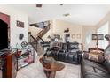 Spacious living room with leather furniture, a wood coffee table, and a staircase at 2210 Kentucky Derby Dr, Orlando, FL 32825