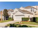 Two-story house with a two-car garage and landscaped front yard at 2249 Wyndham Palms Way, Kissimmee, FL 34747