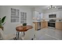 Modern kitchen with stainless steel appliances and light wood cabinets at 2421 Healy Dr, Orlando, FL 32818