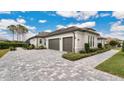 Three-car garage with paver driveway and walkway at 25500 Hawks Run Ln, Sorrento, FL 32776