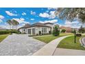 Home with a three-car garage and paver driveway at 25500 Hawks Run Ln, Sorrento, FL 32776