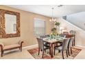 Formal dining room with a table for six and a large mirror at 2616 Santosh Cv, Kissimmee, FL 34746