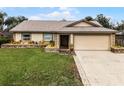 Single-story house with a two-car garage and landscaped yard at 2700 Dorado Ct, Apopka, FL 32703