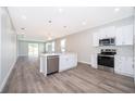 Modern kitchen featuring white shaker cabinets, stainless steel appliances, and a large island at 2712 Alamo Dr, Orlando, FL 32805