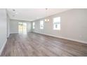 Spacious living area with gray vinyl plank flooring and access to the backyard at 2712 Alamo Dr, Orlando, FL 32805