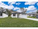 Modern, single-story home with white exterior and attached garage at 2909 S Palmetto Ave, Sanford, FL 32773