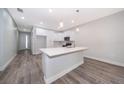 Modern kitchen featuring white cabinets, quartz countertops, and stainless steel appliances at 2909 S Palmetto Ave, Sanford, FL 32773