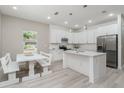 Modern kitchen with white cabinets, stainless steel appliances, and an island at 309 Albany Ave, Deland, FL 32724