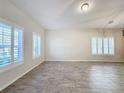 Bright living room featuring tile floors and large windows with plantation shutters at 3465 Middlebrook Pl, Harmony, FL 34773