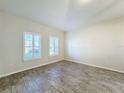 Bright living room with tile flooring, neutral walls, and plantation shutters at 3465 Middlebrook Pl, Harmony, FL 34773