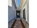 Front entry with brick walkway, stone accents, and dark brown door at 3656 Brighton Park Cir, Orlando, FL 32812