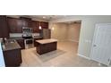 Open concept kitchen with island and adjacent dining area at 3656 Brighton Park Cir, Orlando, FL 32812