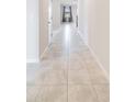 Bright hallway with light gray tile flooring at 3975 Great Smokey Way, Apopka, FL 32712