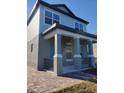 Two-story house with gray siding and a front porch at 419 Venetian Palms Blvd, New Smyrna Beach, FL 32168