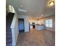 Open living room and kitchen with tile floors at 419 Venetian Palms Blvd, New Smyrna Beach, FL 32168