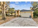 Single-story house with a large driveway and mature trees at 4239 Shades Crest Ln, Sanford, FL 32773