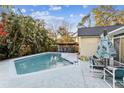 Inviting kidney shaped pool, surrounded by a patio and tropical plants at 4239 Shades Crest Ln, Sanford, FL 32773