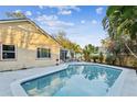 Relaxing kidney-shaped pool with patio and lush tropical landscaping at 4239 Shades Crest Ln, Sanford, FL 32773