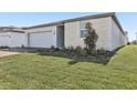 A well manicured lawn surrounds this single Gathering home with a brick driveway at 4508 Windy Oak Way, St Cloud, FL 34772