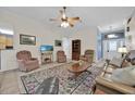 Living room with two armchairs, a sofa, and a coffee table at 490 Sweetwater Way, Haines City, FL 33844