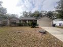 One-story house with attached garage and manicured lawn at 5022 Log Wagon Rd, Ocoee, FL 34761