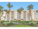 Attractive beachfront condo building with palm trees and lush landscaping at 5300 S Atlantic Ave # 604, New Smyrna Beach, FL 32169