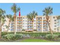 Three-story condo building with balconies and lush landscaping at 5300 S Atlantic Ave # 604, New Smyrna Beach, FL 32169