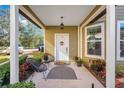 Covered front porch with seating area and stylish rug at 543 Sunbranch Ln, Casselberry, FL 32707