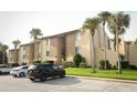 Condo building with palm trees and parking at 596 Orange Dr # 151, Altamonte Springs, FL 32701