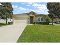 One-story house with stone accents and a two-car garage at 745 Andrew St, Eustis, FL 32726