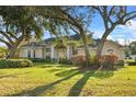 House exterior showcasing a large yard with lush landscaping at 107 Alexandra Woods Dr, Debary, FL 32713