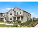 Two-story house with gray siding, shutters, and a landscaped lawn at 11833 Founders St, Orlando, FL 32832