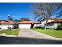 House exterior showcasing a two car garage and well maintained lawn at 142 Sandy Point Way, Clermont, FL 34714