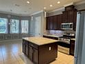 Kitchen featuring granite countertops, stainless steel appliances and an island at 15041 Gaulberry Run, Winter Garden, FL 34787