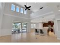 A spacious living room with large windows and sliding doors leading to the backyard and open floor plan at 15041 Gaulberry Run, Winter Garden, FL 34787