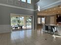 Bright living room featuring tile floors, high ceilings, and access to the screened lanai and pool at 15041 Gaulberry Run, Winter Garden, FL 34787