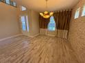 Elegant dining room with wood-look tile floors and stone wall at 15306 Southern Martin St, Winter Garden, FL 34787