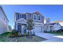 Two-story house with gray siding, attached garage, and landscaping at 1534 Marksman Rd, Eagle Lake, FL 33839